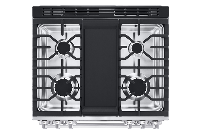 Close-up of heavy-duty black cast iron grates on a stainless steel gas range cooktop.